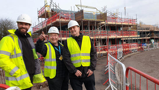 Three Team Members On Building Site