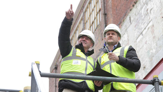 Two Team Members On Building Site